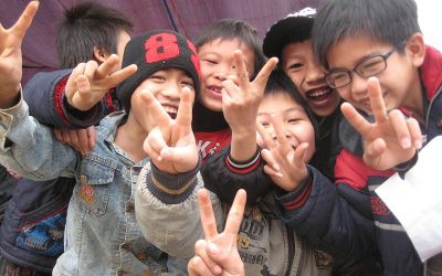 Why Do Many Asians Use the V or Peace Sign in Photographs?