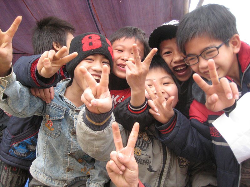 Why Do Many Asians Use the V or Peace Sign in Photographs?