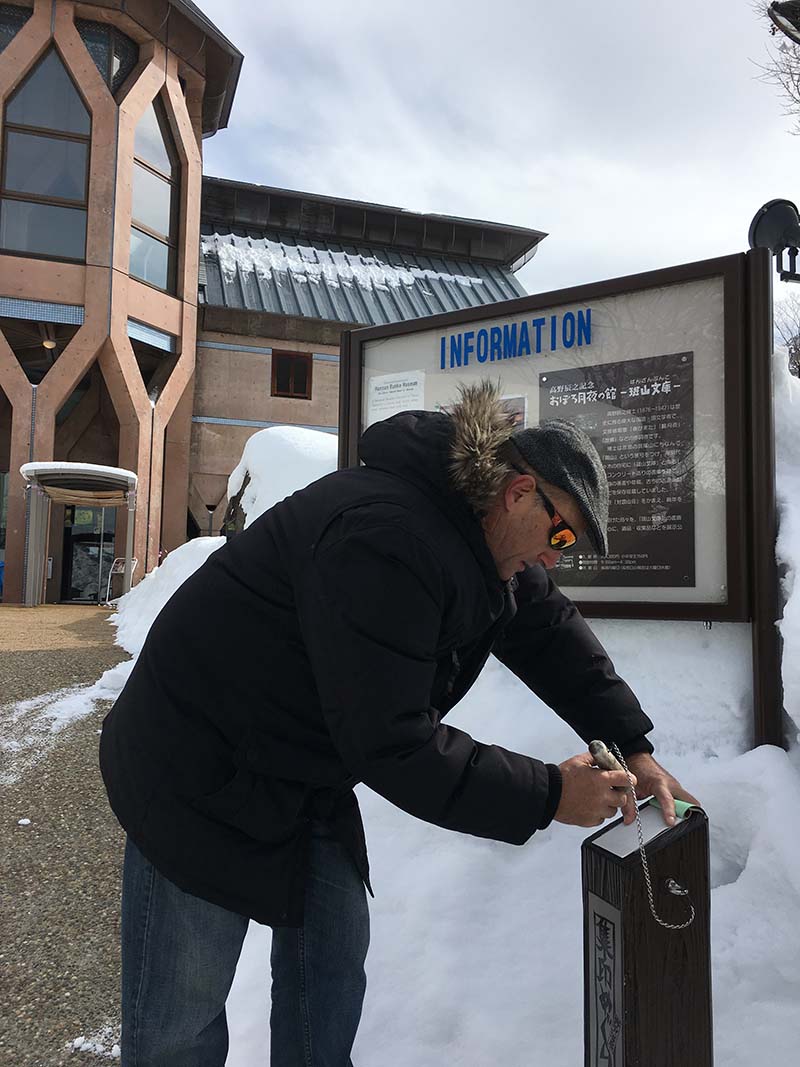 a man in sunglasses, hat and faux fur jacket on An Onsen Crawl in Nozawa Onsen, Japan